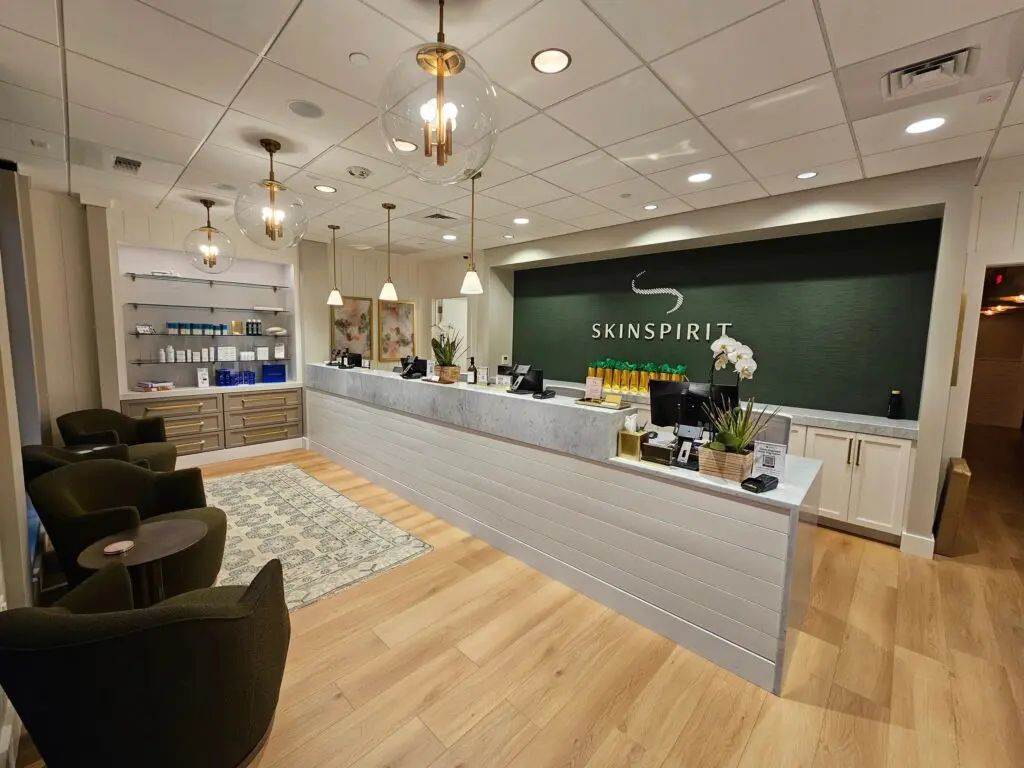 A reception area with a large green wall.