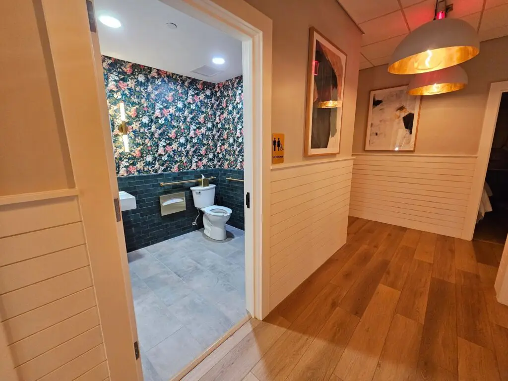 A bathroom with two toilets and a mirror.