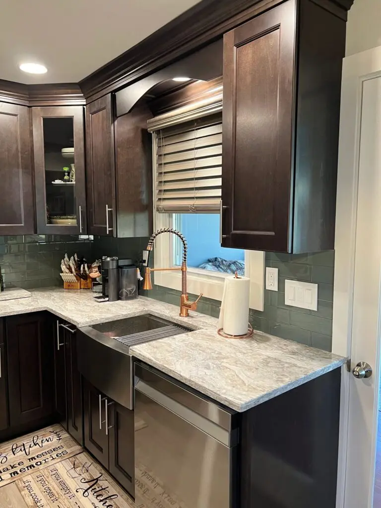 A kitchen with brown cabinets and white counter tops.