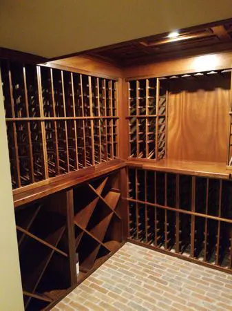 A wine cellar with many wooden racks and shelves.