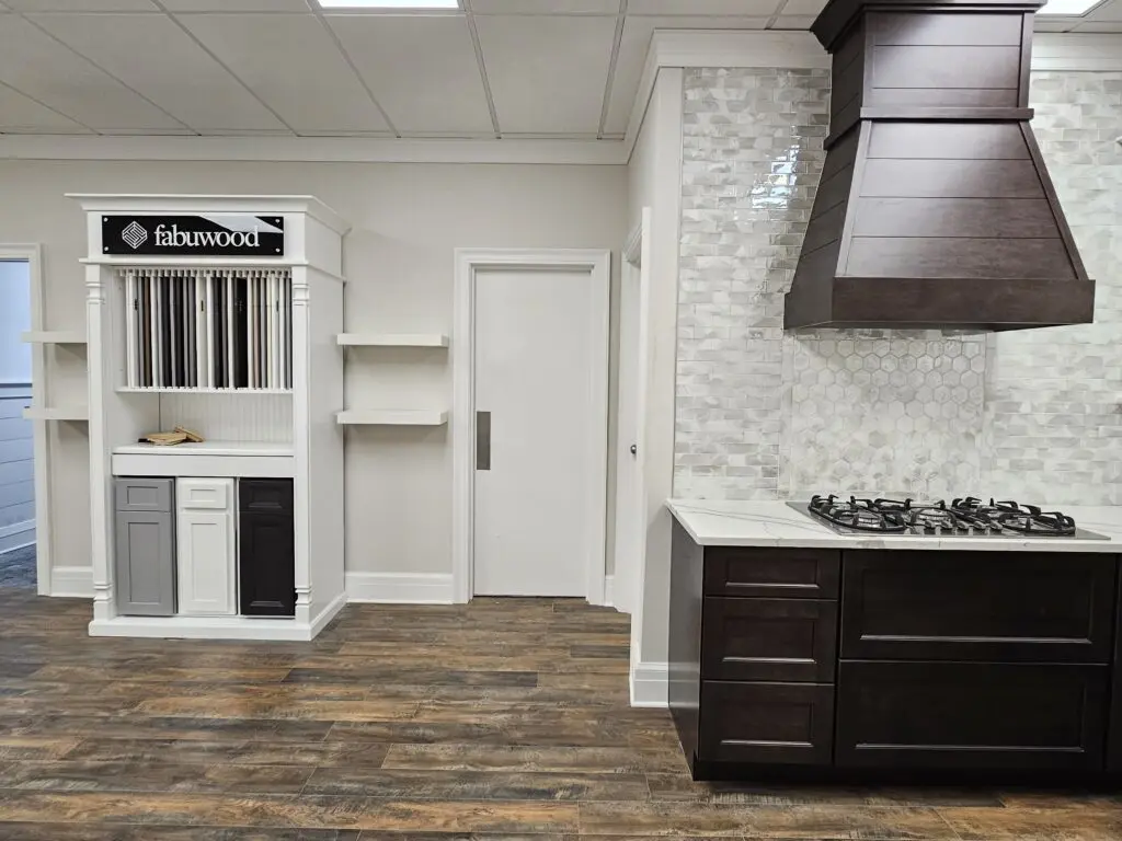 A kitchen with wood floors and white walls.