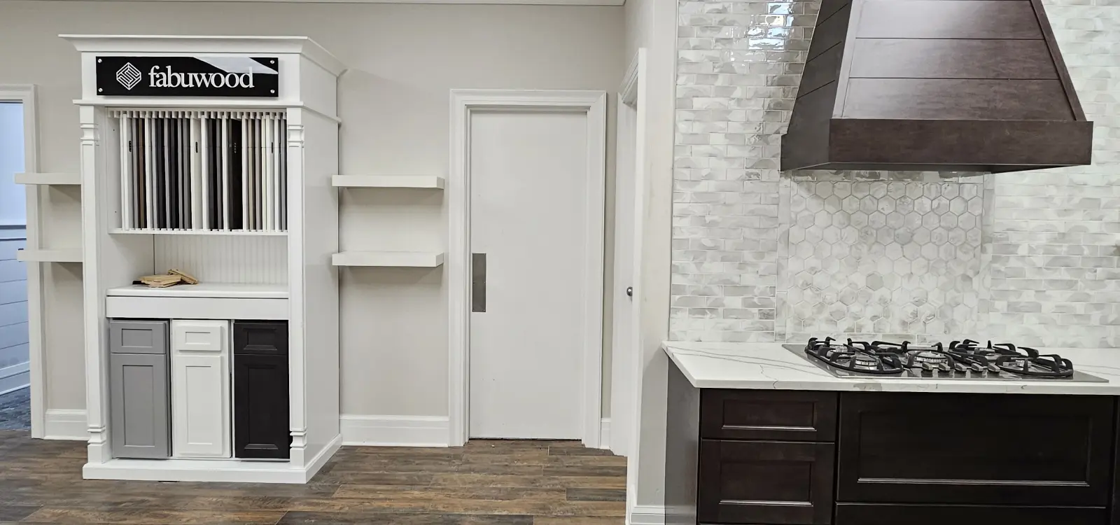 A white door and shelves in the corner of a room.