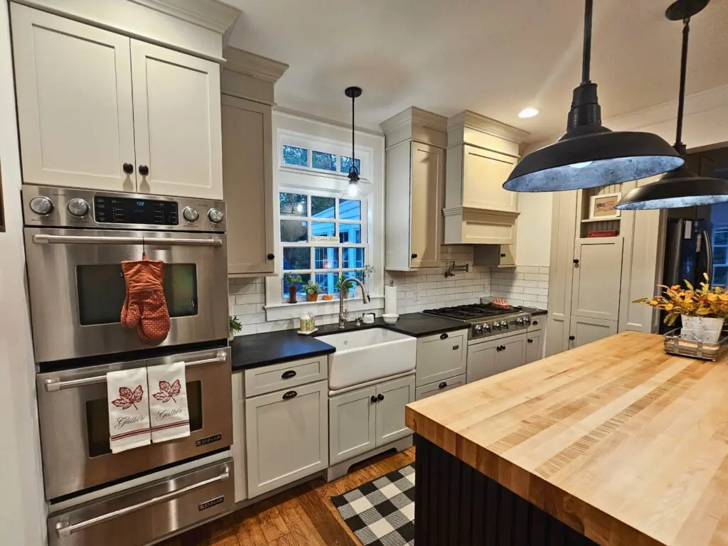 Impecca-Bull kitchen with sage green shaker cabinets and black island