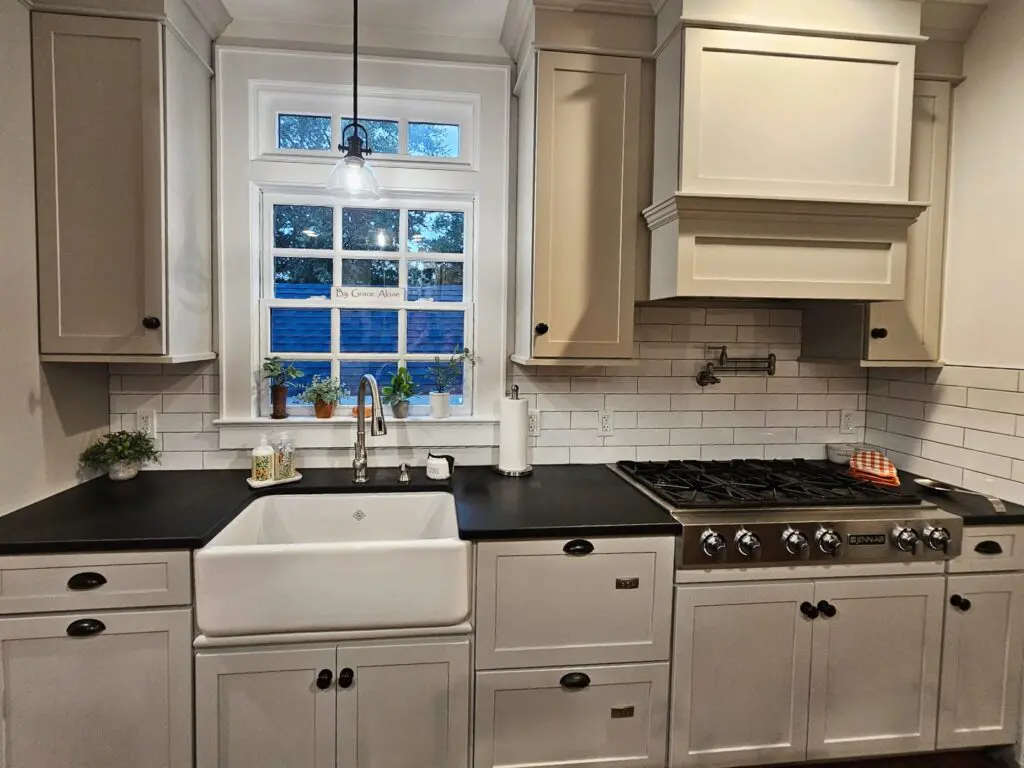 Impecca-Bull kitchen with sage green shaker cabinets with traditional farmhouse sink