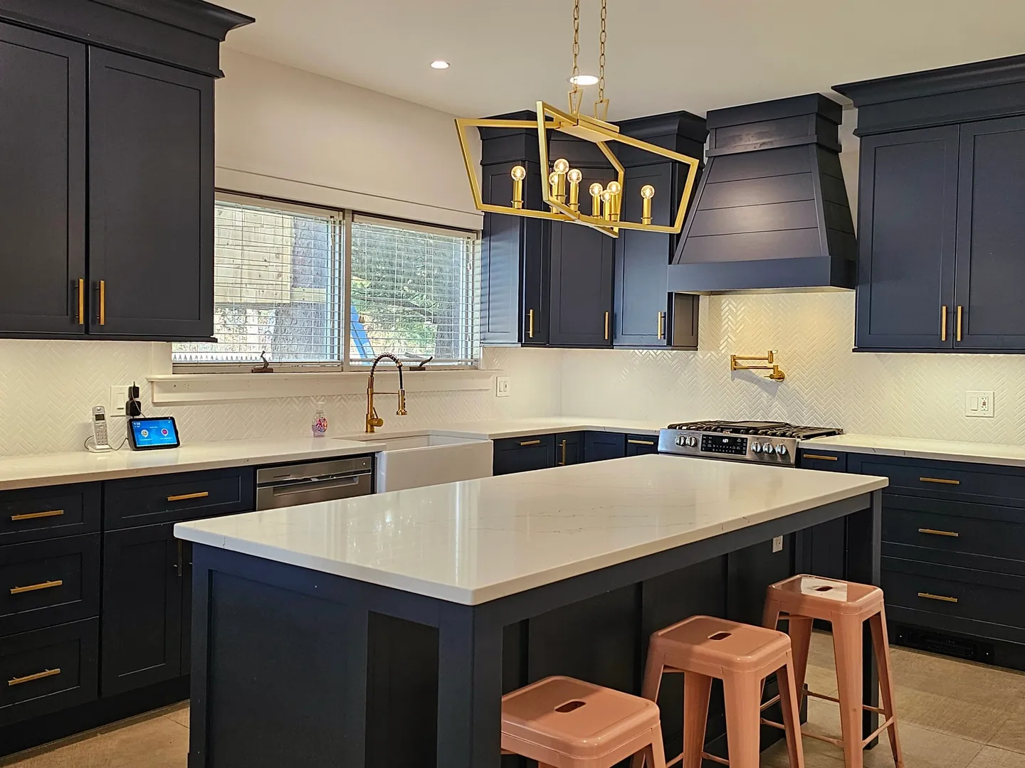 A kitchen with black cabinets and white counter tops.